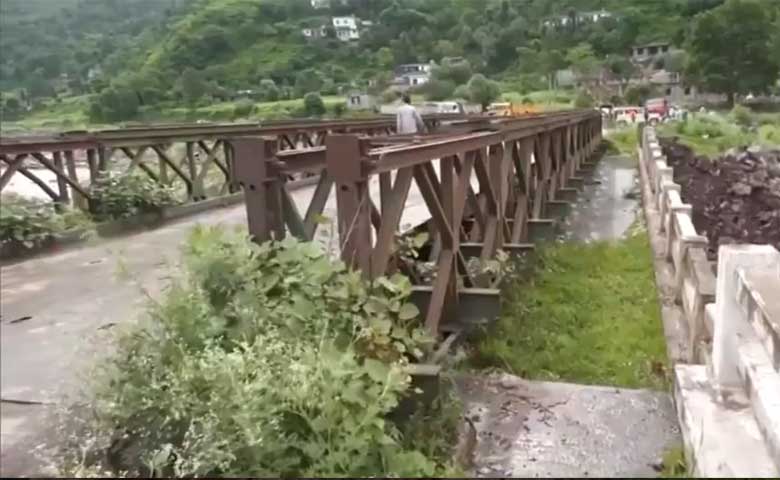 Bridge partially washed away by heavy rains